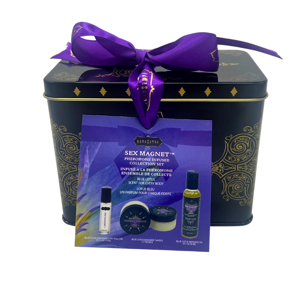 A gift set from SEX MAGNET™, Blue Lotus Pheromone Collection, displayed in a black tin with gold designs, containing a roll-on fragrance, massage oil, and a massage candle, all tied with a purple ribbon. The set is marketed for foreplay and is TSA approved for travel.