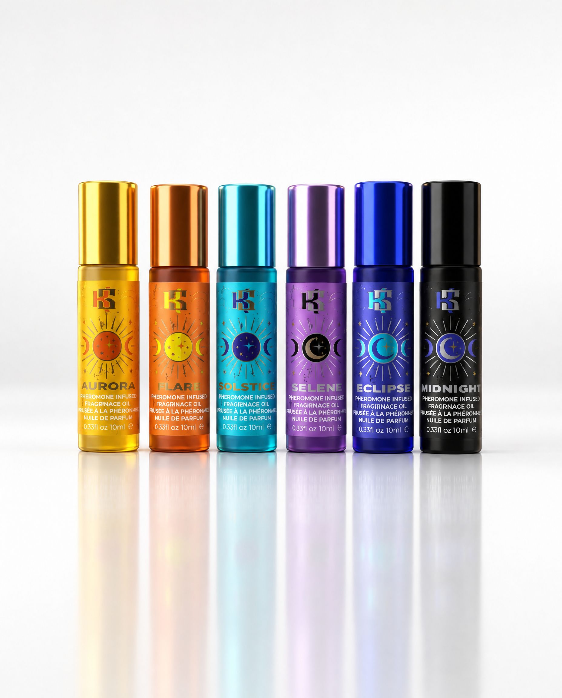 Six small cylindrical perfume or fragrance oil bottles with metallic caps are lined up on a white reflective surface against a white background. The bottles are labeled with colorful sun and moon symbols and names including Aurora, Apollo, Selene, Eclipse, Midnight, and Luna.