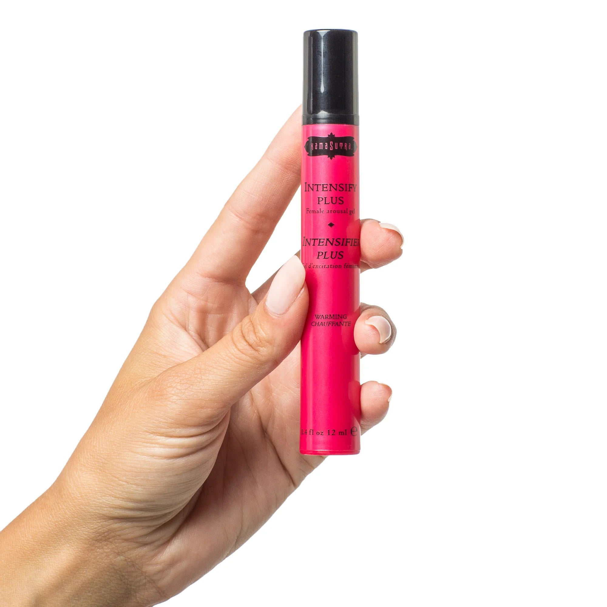 Hand holding a pink tube with black cap containing Intesifying gel warming on a white background
