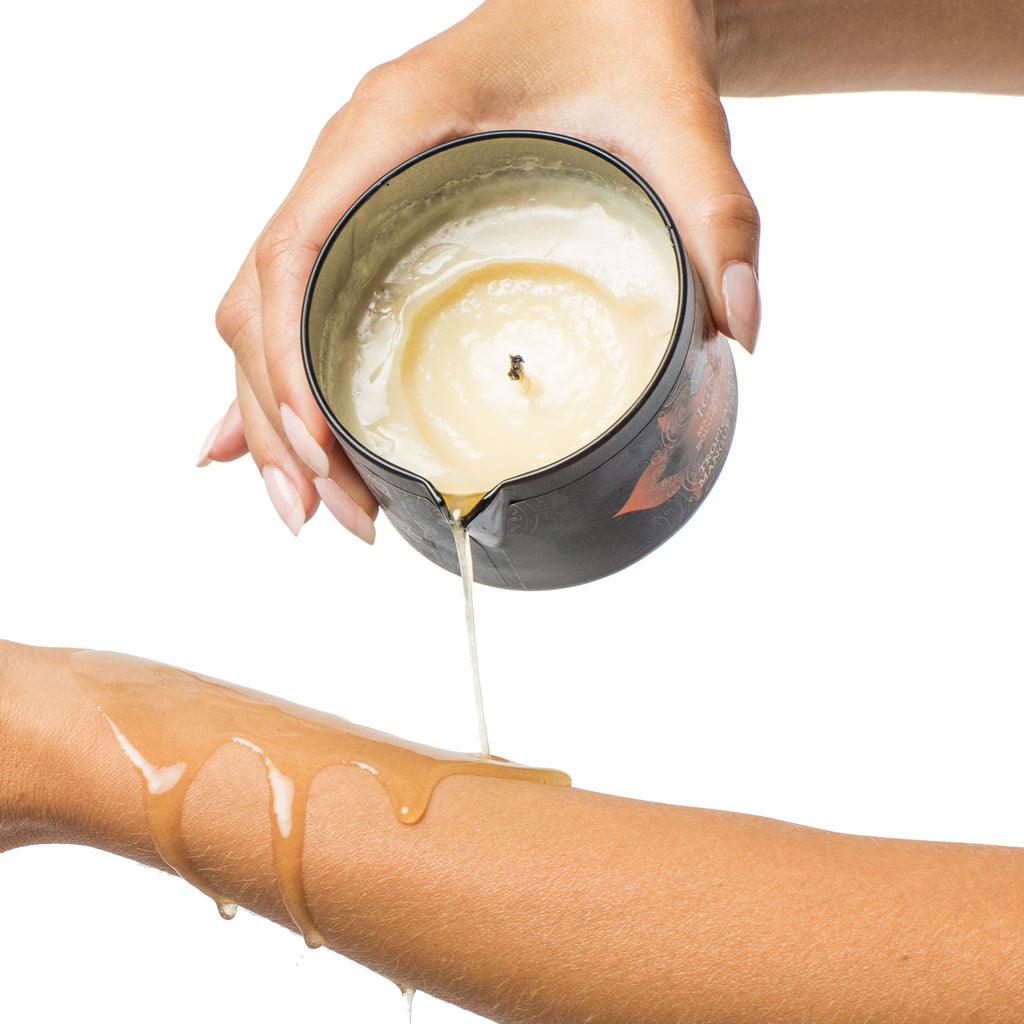 Ignite Massage Oil Candle  being poured onto the arm of model - The Kama Sutra Company