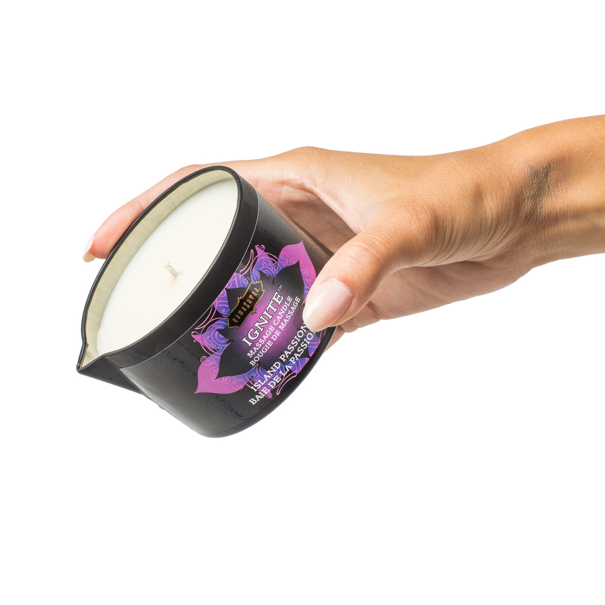 Ignite Massage Oil Candle Island Passion Berry in models hand - The Kama Sutra Company