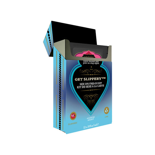 The image displays an open box of Kama Sutra GET SLIPPERY Sex-To-Go Kit, containing 12 single-use packets of assorted water-based lube in flavors such as coconut pineapple, strawberry dreams, and vanilla cream.